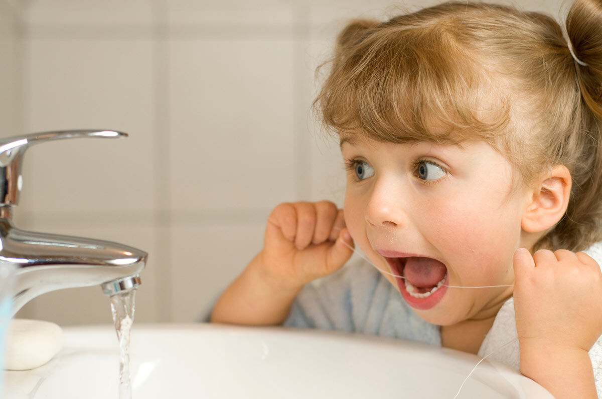 flossing childs teeth