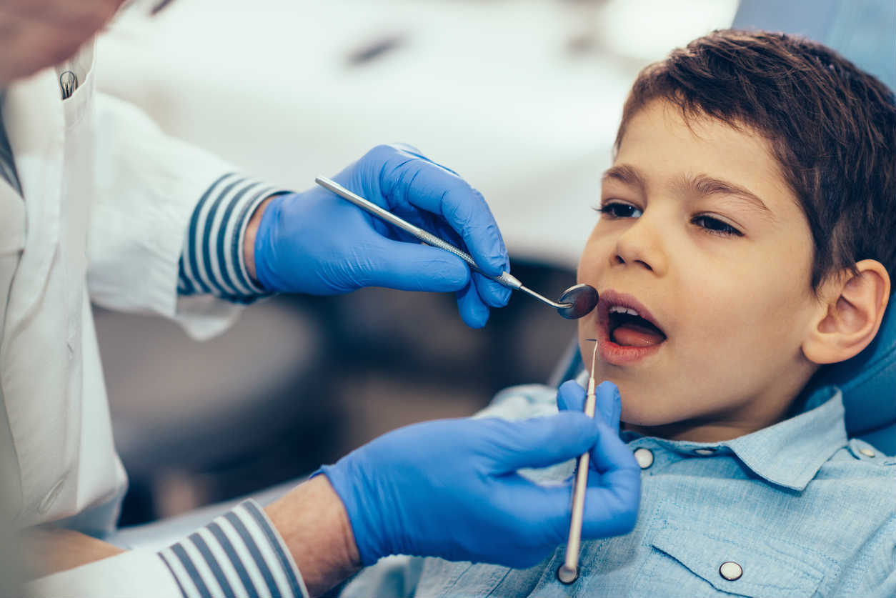 child getting a check up at dentist