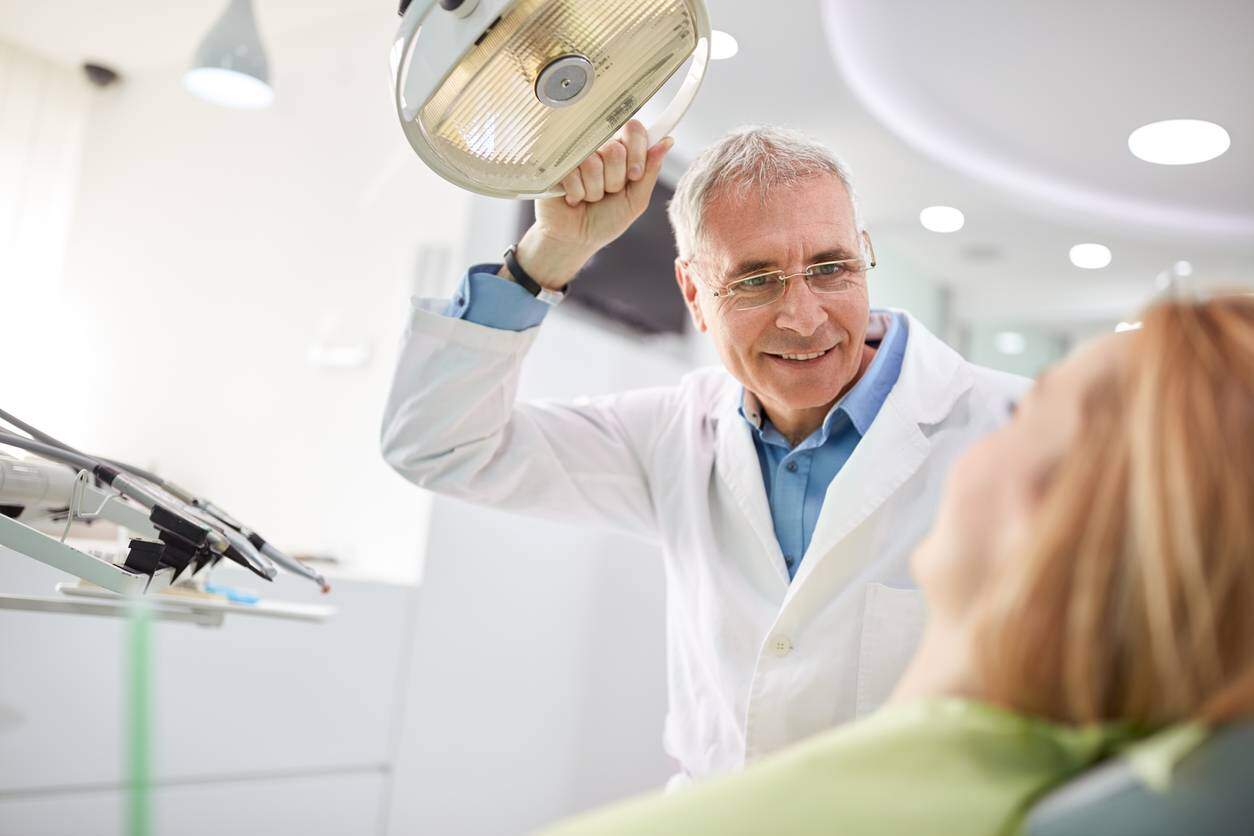 woman speaking with St. Louis dentist