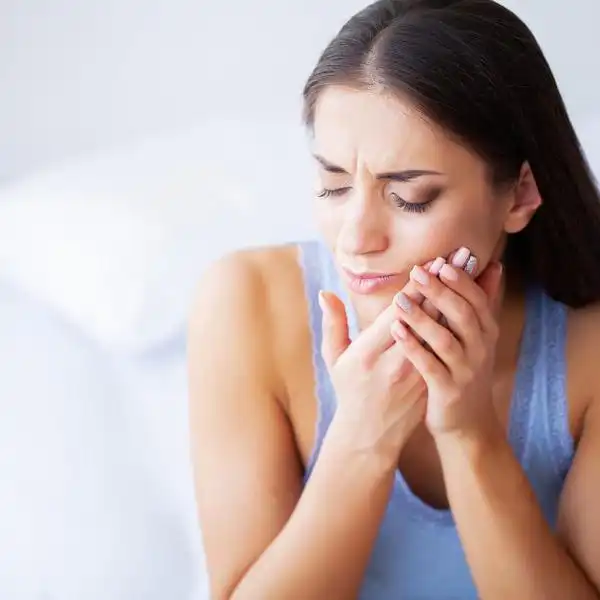 woman with pain from grinding her teeth